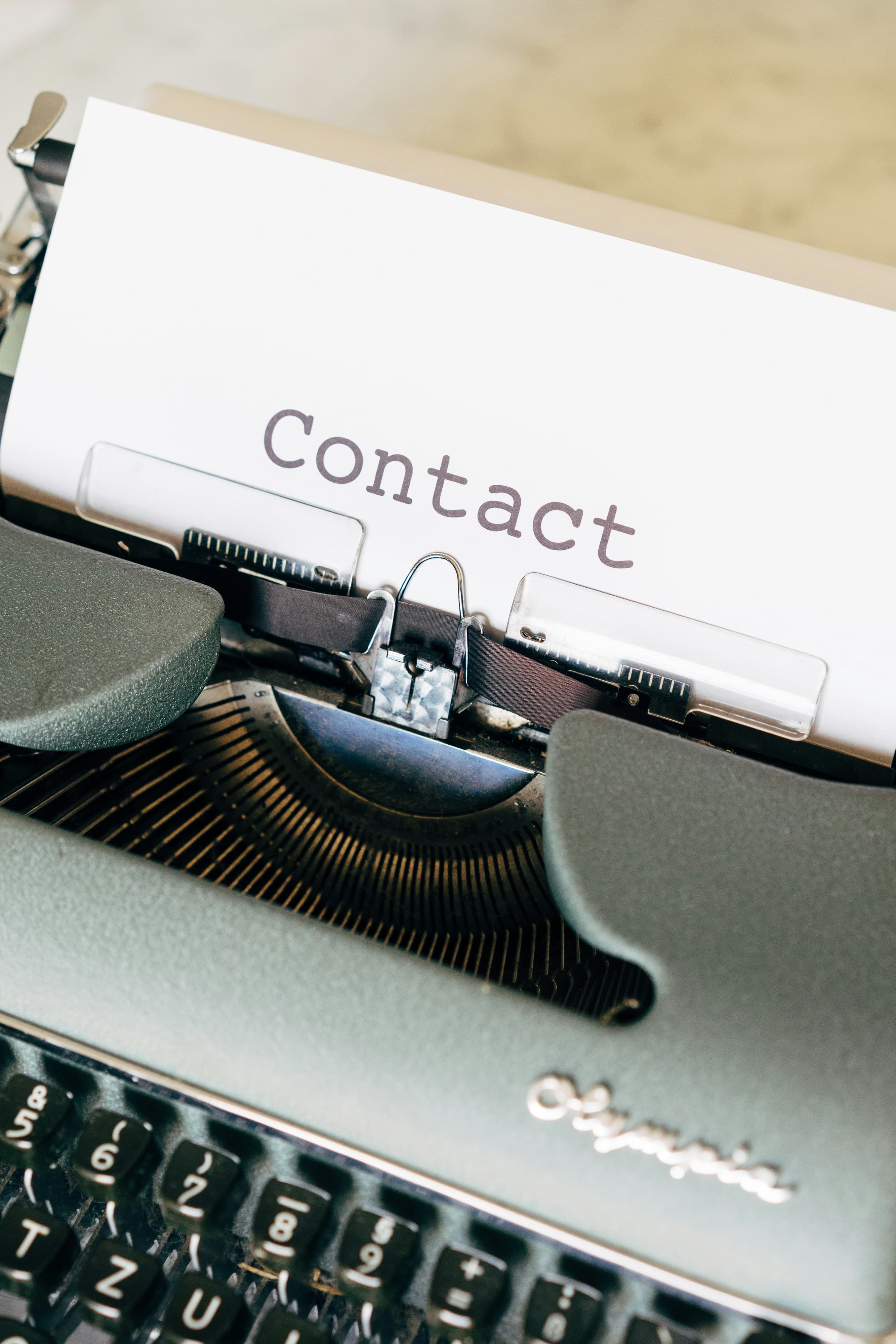 black Fayorit typewriter with the word contact on the paper